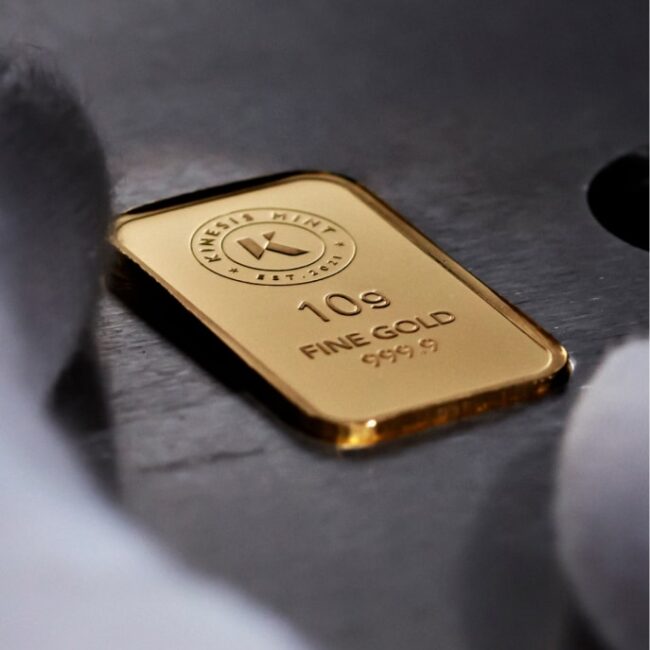 A Kinesis branded gold bullion bar, freshly stamped and about to be inspected